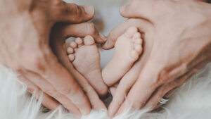 baby feet held by parents hands