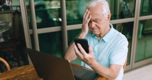 Man looking at his phone dismayed