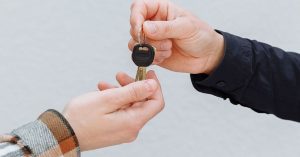parent handing car keys to a teenager