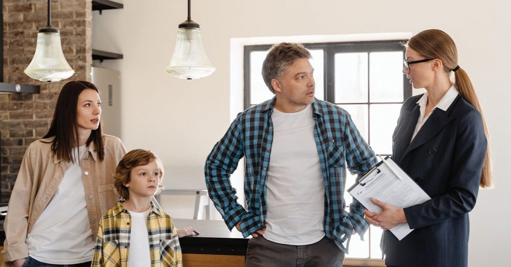 family talking with a rental agent