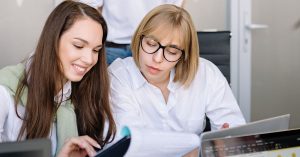 two business owners reviewing their workers' compensation
