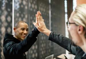 Coworkers high fiving each other