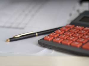 Pen on table next to calculator