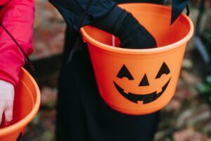 Children carrying buckets trick-or-treating