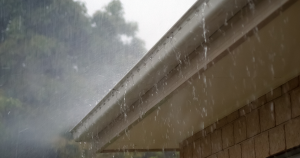 Rain pouring down over gutters