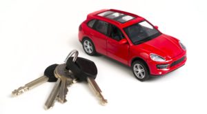 Car keys next to a toy car