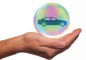 Hand holding bubble with a car icon inside