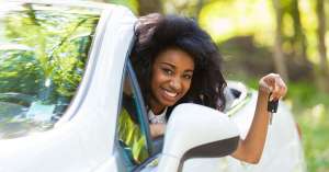 Woman in convertible holding car keys