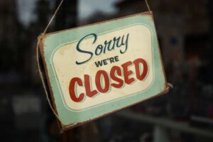 Closed sign hung in business window