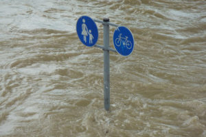 Flood waters surrounding a road sign